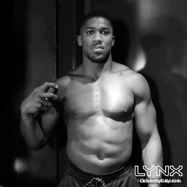 Anthony Joshua shows off his muscular physique during 